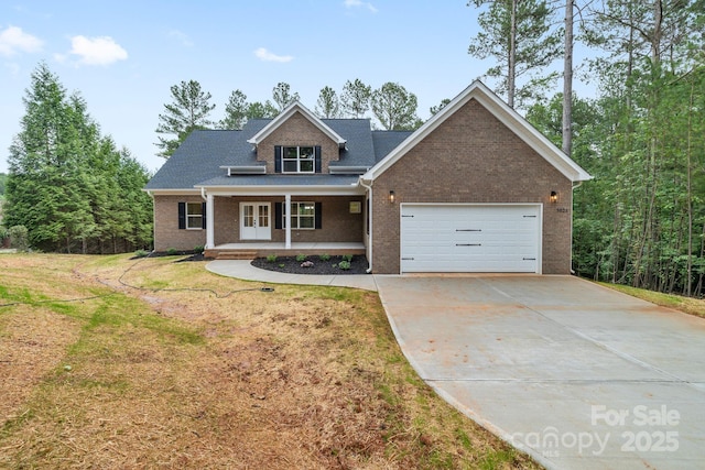 5025 Harbor View Dr E, Granite Falls, NC 28630 - view of front of house featuring a garage, concrete driveway, covered porch, brick siding, and a front yard