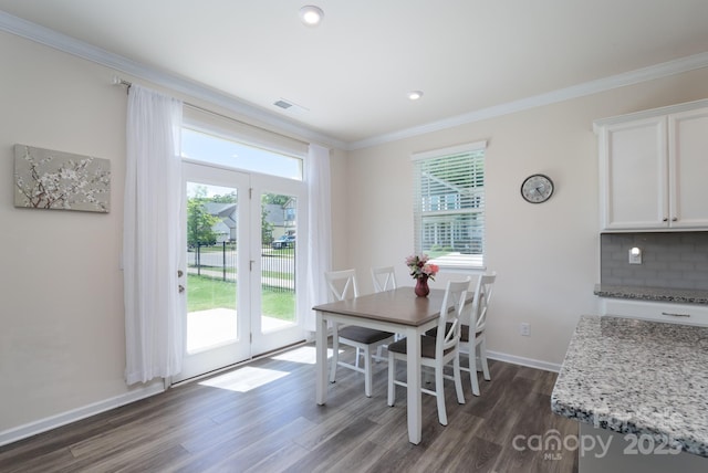 1004 Earlston Rd, Indian Trail, NC 28079 - dining space featuring crown molding, dark wood-style floors, plenty of natural light, baseboards, and recessed lighting