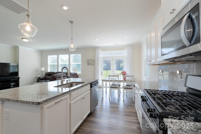 1004 Earlston Rd, Indian Trail, NC 28079 - kitchen featuring stainless steel appliances, a sink, crown molding, decorative backsplash, and dark wood-style floors