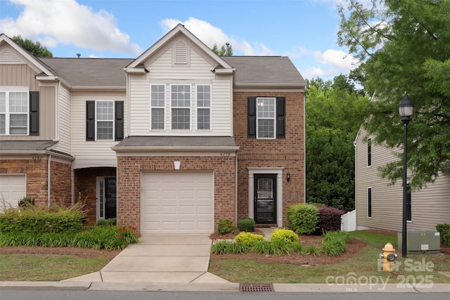 4278 Park S Station Blvd, Charlotte, NC 28210 - view of front of home with brick siding, a garage, driveway, and roof with shingles