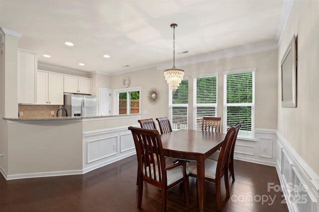 4278 Park S Station Blvd, Charlotte, NC 28210 - dining space featuring dark wood-style flooring, a decorative wall, a chandelier, crown molding, and recessed lighting