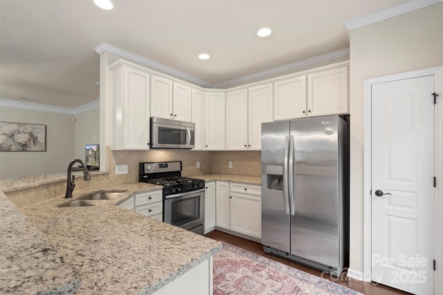 4278 Park S Station Blvd, Charlotte, NC 28210 - kitchen with appliances with stainless steel finishes, a sink, a peninsula, crown molding, and light stone counters