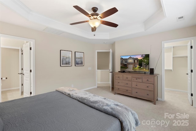 4278 Park S Station Blvd, Charlotte, NC 28210 - bedroom with a tray ceiling, a spacious closet, light carpet, baseboards, and crown molding
