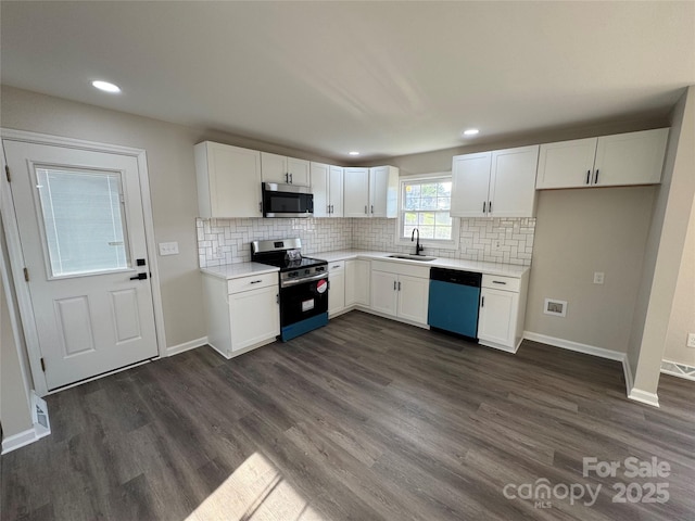 1735 Hollandale Dr, Gastonia, NC 28054 - kitchen with appliances with stainless steel finishes, a sink, white cabinetry, tasteful backsplash, and light countertops