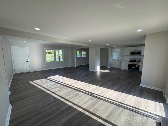 1735 Hollandale Dr, Gastonia, NC 28054 - unfurnished living room featuring baseboards, dark wood-style floors, and recessed lighting