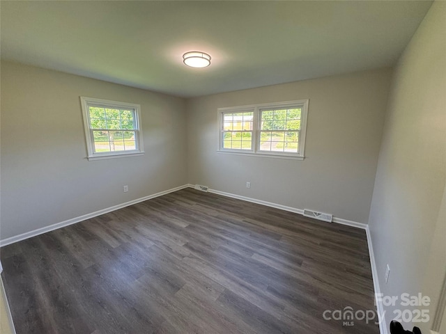 1735 Hollandale Dr, Gastonia, NC 28054 - spare room featuring healthy amount of natural light, baseboards, and dark wood finished floors