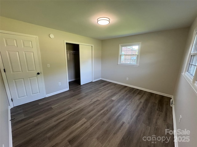 1735 Hollandale Dr, Gastonia, NC 28054 - unfurnished bedroom with dark wood-type flooring, baseboards, and a closet