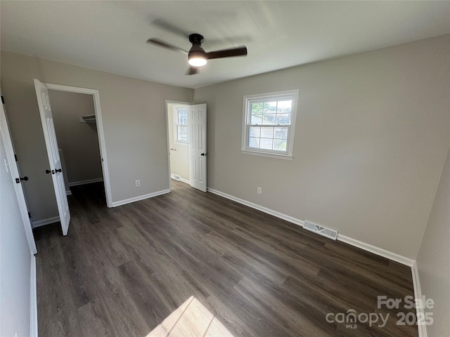 1735 Hollandale Dr, Gastonia, NC 28054 - unfurnished bedroom with dark wood-style flooring, a spacious closet, baseboards, ceiling fan, and a closet