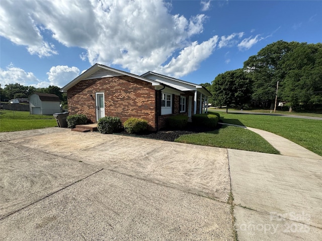 1735 Hollandale Dr, Gastonia, NC 28054 - view of side of property with brick siding, driveway, and a lawn