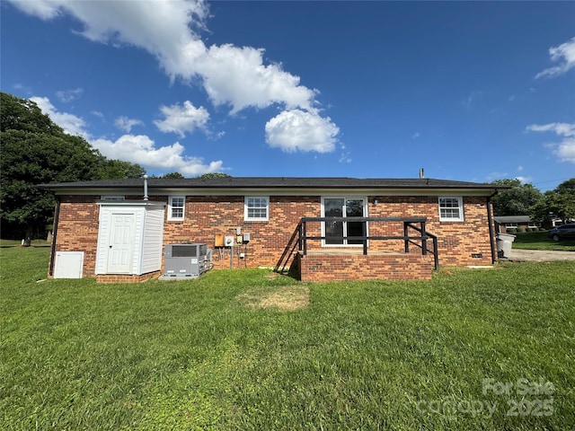 1735 Hollandale Dr, Gastonia, NC 28054 - back of house with central air condition unit, brick siding, and a yard