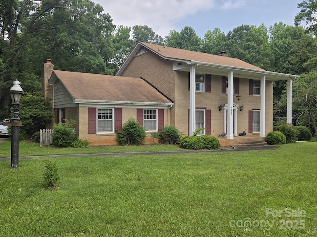 9225 Robinson Church Rd, Charlotte, NC 28215 - neoclassical / greek revival house with a chimney, brick siding, a front lawn, and roof with shingles