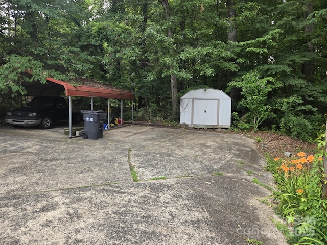 9225 Robinson Church Rd, Charlotte, NC 28215 - view of parking with a carport, a storage shed, and driveway
