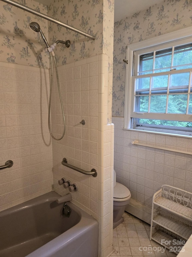 9225 Robinson Church Rd, Charlotte, NC 28215 - bathroom featuring wallpapered walls, a wainscoted wall, washtub / shower combination, tile walls, and tile patterned floors