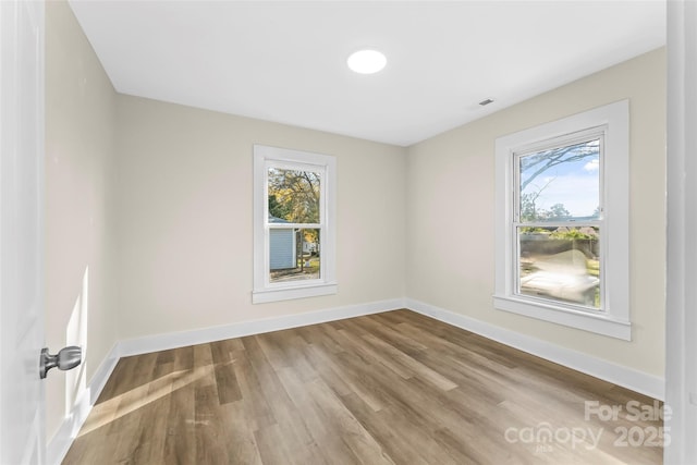 1102 Venus St, Kannapolis, NC 28083 - unfurnished room with plenty of natural light, wood finished floors, and baseboards