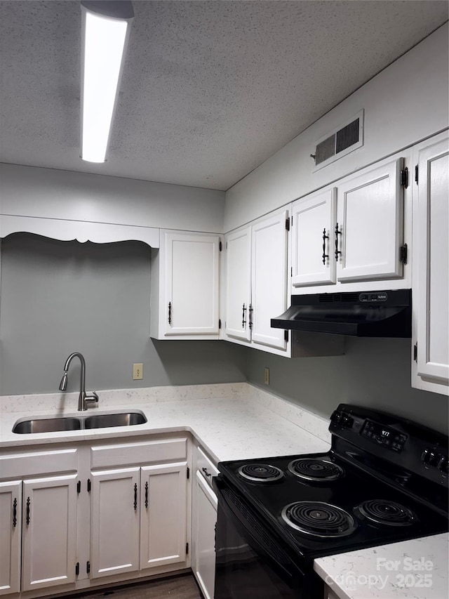 2106 S Main St, Kannapolis, NC 28081 - kitchen featuring black / electric stove, under cabinet range hood, a sink, white cabinetry, and a textured ceiling