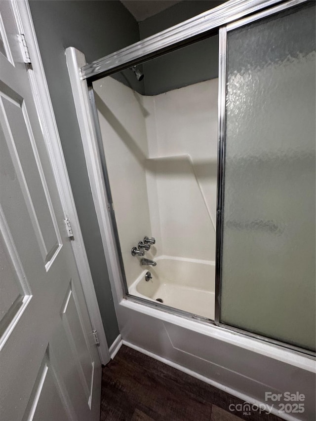 2106 S Main St, Kannapolis, NC 28081 - bathroom featuring wood finished floors, shower / bath combination with glass door, and baseboards