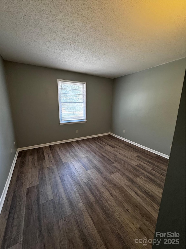 2106 S Main St, Kannapolis, NC 28081 - empty room featuring dark wood-style floors, a textured ceiling, and baseboards