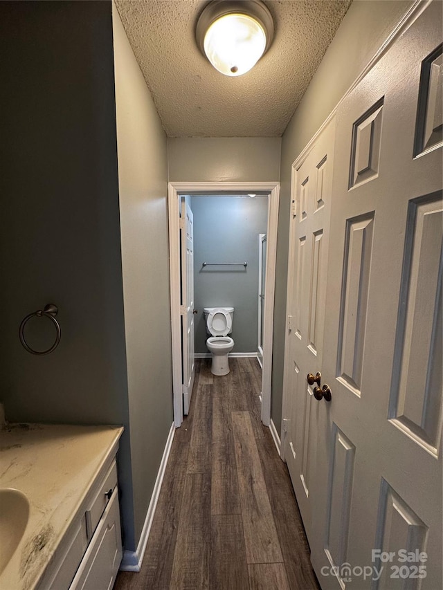 2106 S Main St, Kannapolis, NC 28081 - hallway with dark wood-type flooring, a textured ceiling, and baseboards