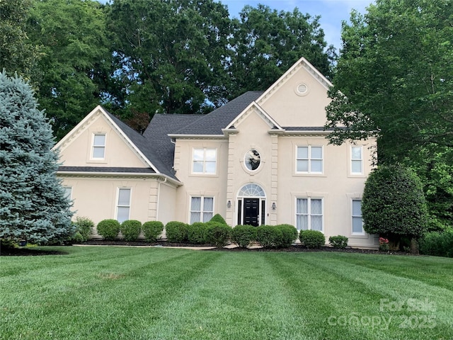 12711 Duncourtney Ln, Charlotte, NC 28277 - view of front of home featuring stucco siding, a front yard, and roof with shingles