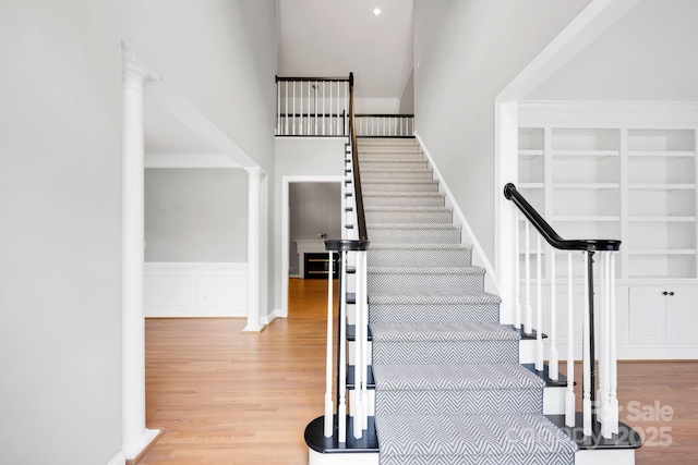 12711 Duncourtney Ln, Charlotte, NC 28277 - stairs with wood finished floors, built in shelves, and a high ceiling