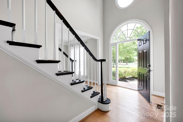 12711 Duncourtney Ln, Charlotte, NC 28277 - foyer featuring light wood-type flooring, baseboards, stairs, and a towering ceiling