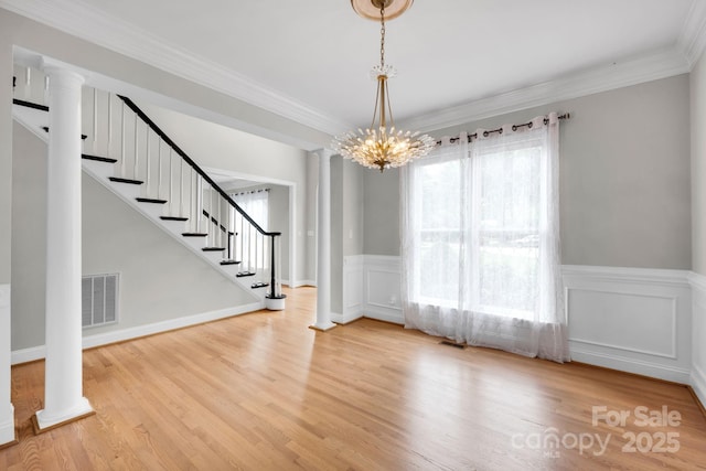 12711 Duncourtney Ln, Charlotte, NC 28277 - unfurnished dining area featuring ornate columns, stairs, wood finished floors, a wainscoted wall, and crown molding
