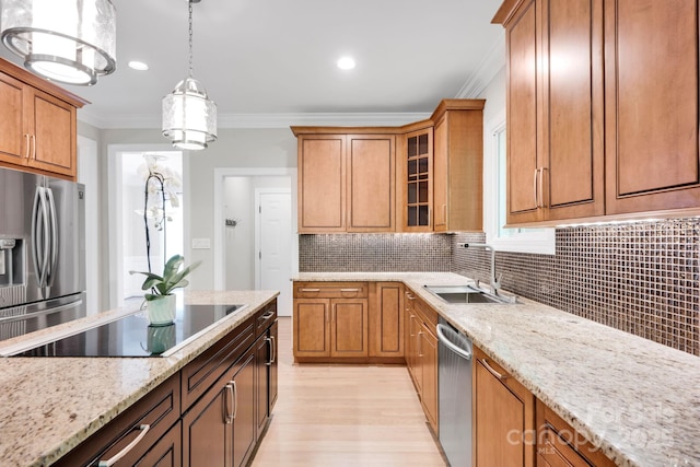 12711 Duncourtney Ln, Charlotte, NC 28277 - kitchen featuring appliances with stainless steel finishes, a sink, crown molding, light wood-type flooring, and light stone countertops