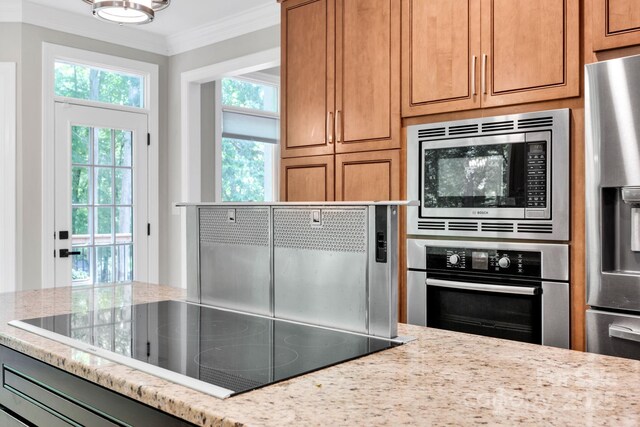 12711 Duncourtney Ln, Charlotte, NC 28277 - kitchen featuring stainless steel appliances, ornamental molding, light stone countertops, and brown cabinets