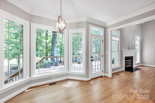 12711 Duncourtney Ln, Charlotte, NC 28277 - unfurnished dining area featuring healthy amount of natural light, a chandelier, wood finished floors, baseboards, and ornamental molding