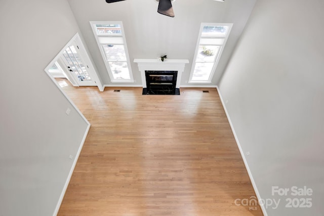 12711 Duncourtney Ln, Charlotte, NC 28277 - unfurnished living room featuring baseboards, a ceiling fan, wood finished floors, and a premium fireplace