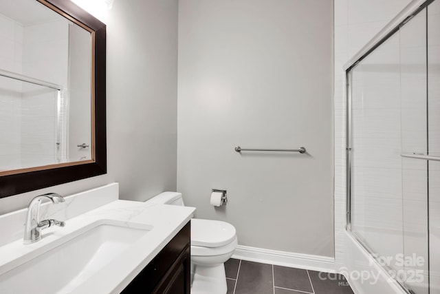 12711 Duncourtney Ln, Charlotte, NC 28277 - bathroom with toilet, vanity, tile patterned floors, shower / bath combination with glass door, and baseboards