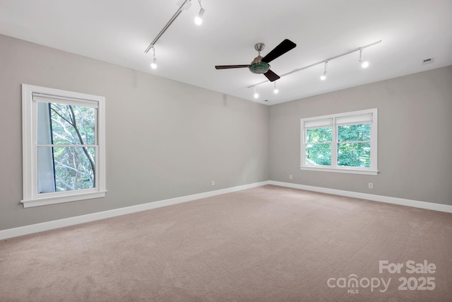 12711 Duncourtney Ln, Charlotte, NC 28277 - spare room featuring track lighting, light colored carpet, a ceiling fan, and baseboards