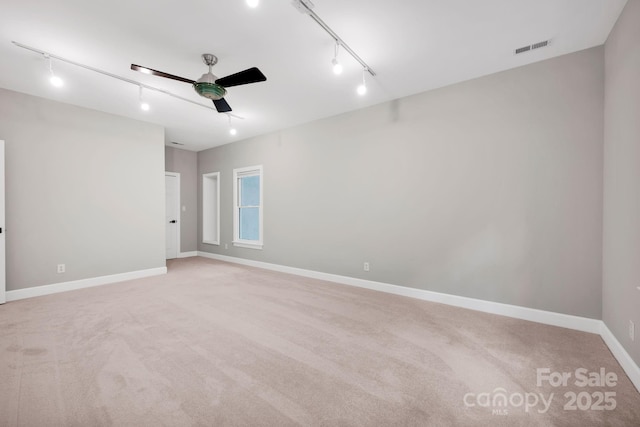12711 Duncourtney Ln, Charlotte, NC 28277 - spare room with track lighting, ceiling fan, light carpet, and baseboards