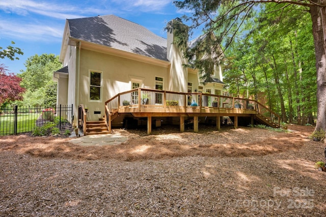 12711 Duncourtney Ln, Charlotte, NC 28277 - back of property featuring a chimney, stucco siding, stairway, a wooden deck, and roof with shingles