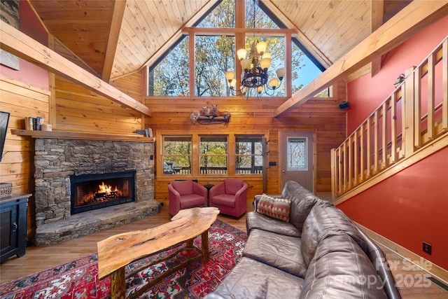 339 Tsalagi Trl, Maggie Valley, NC 28751 - living room featuring a stone fireplace, wood finished floors, wooden walls, plenty of natural light, and wood ceiling