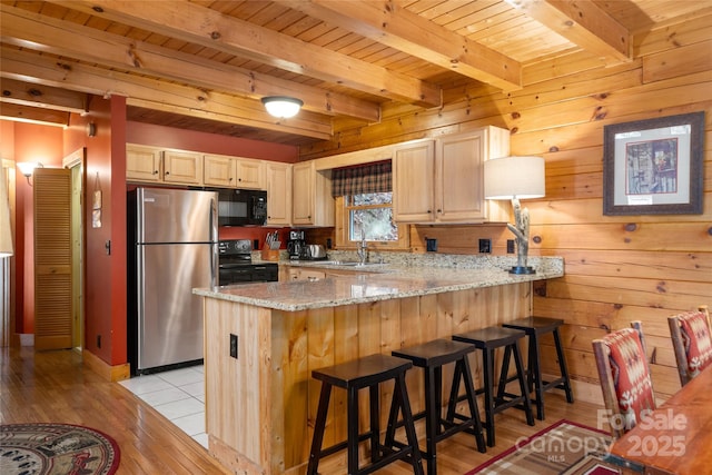 339 Tsalagi Trl, Maggie Valley, NC 28751 - kitchen featuring black appliances, a peninsula, wooden ceiling with exposed beams, light brown cabinets, and light wood finished floors