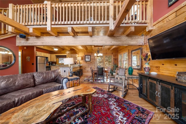339 Tsalagi Trl, Maggie Valley, NC 28751 - living area featuring wood walls, light wood finished floors, and wooden ceiling with exposed beams