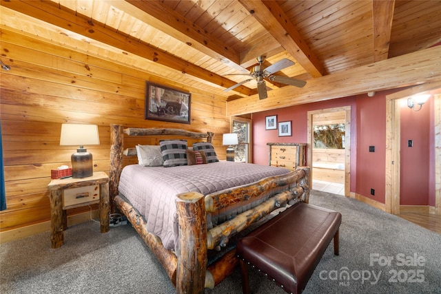 339 Tsalagi Trl, Maggie Valley, NC 28751 - bedroom with wooden ceiling with exposed beams, carpet, wood walls, baseboards, and ensuite bathroom