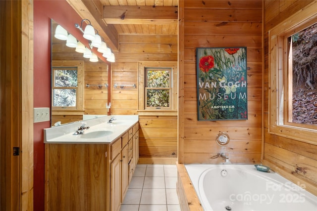 339 Tsalagi Trl, Maggie Valley, NC 28751 - bathroom featuring double vanity, a bath, wooden walls, plenty of natural light, and tile patterned flooring