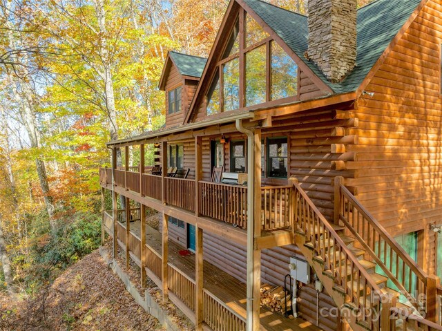 339 Tsalagi Trl, Maggie Valley, NC 28751 - view of side of home with roof with shingles, stairway, a chimney, and log exterior