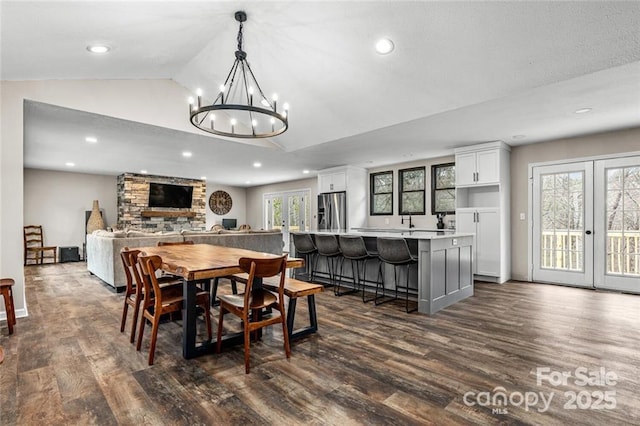 137 Weaver Ct, Lake Lure, NC 28746 - dining room featuring dark wood finished floors, vaulted ceiling, recessed lighting, and a chandelier