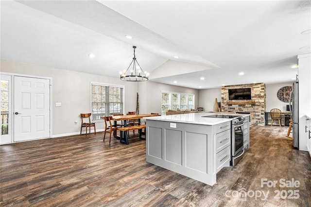 137 Weaver Ct, Lake Lure, NC 28746 - kitchen with stainless steel range oven, lofted ceiling, open floor plan, dark wood finished floors, and gray cabinetry