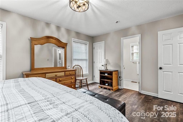 137 Weaver Ct, Lake Lure, NC 28746 - bedroom featuring dark wood-type flooring, baseboards, and a textured ceiling
