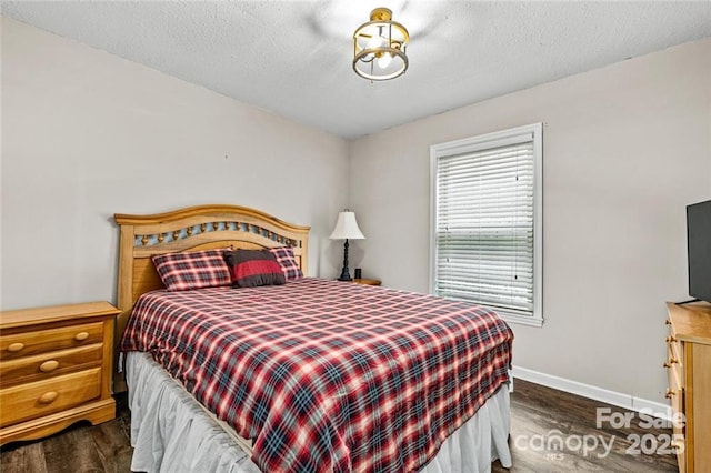 137 Weaver Ct, Lake Lure, NC 28746 - bedroom with dark wood-style floors, baseboards, and a textured ceiling