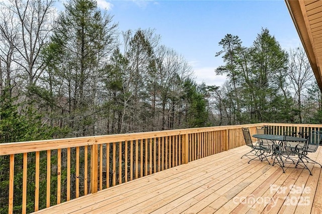 137 Weaver Ct, Lake Lure, NC 28746 - deck featuring outdoor dining area and view of wooded area