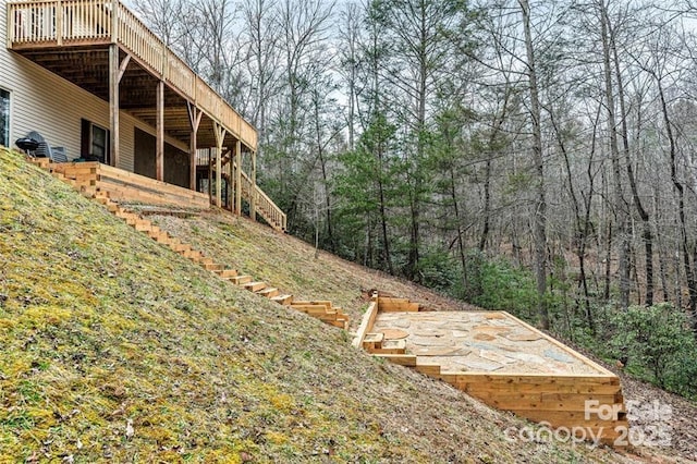 137 Weaver Ct, Lake Lure, NC 28746 - view of yard with stairway, a deck, and a view of trees