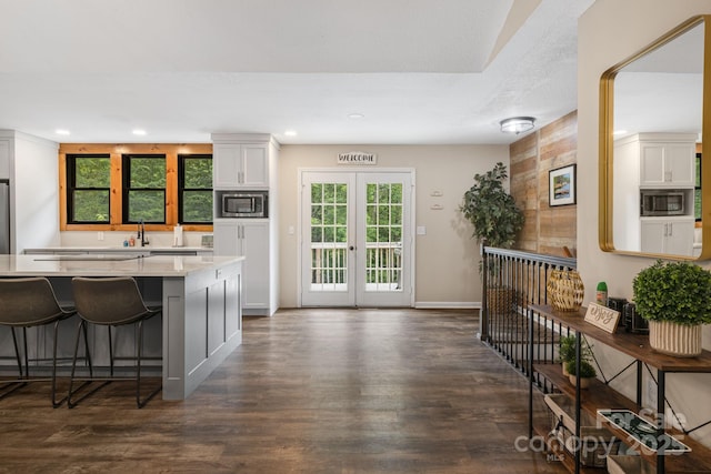 137 Weaver Ct, Lake Lure, NC 28746 - kitchen featuring stainless steel microwave, light countertops, dark wood-style floors, a breakfast bar, and recessed lighting