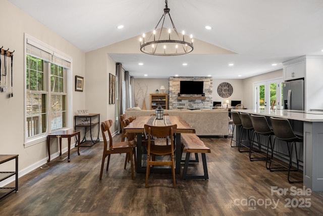 137 Weaver Ct, Lake Lure, NC 28746 - dining area with vaulted ceiling, a chandelier, a stone fireplace, dark wood-style floors, and recessed lighting