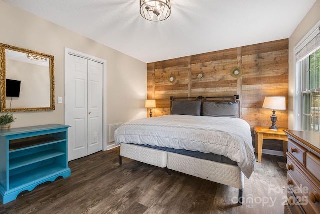 137 Weaver Ct, Lake Lure, NC 28746 - bedroom featuring wooden walls, wood finished floors, and a closet