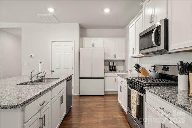 461 Misty Law Ln, Clover, SC 29710 - kitchen featuring appliances with stainless steel finishes, a sink, white cabinetry, tasteful backsplash, and dark wood-type flooring